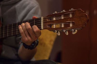 Cropped hand of man playing guitar