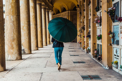 Rear view of woman walking on building