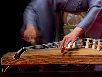 Cropped image of musician playing musical instrument