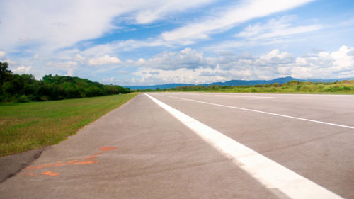 Road by landscape against sky