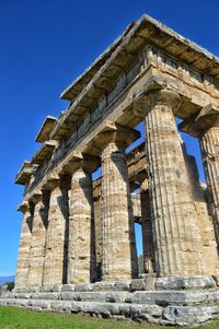 Low angle view of historical building against blue sky