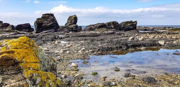 Rocks on shore against sky