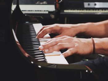 Cropped image of man playing piano