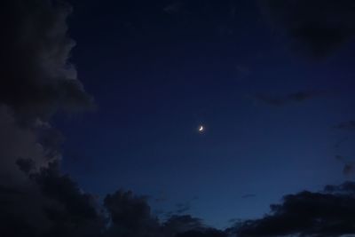 Low angle view of moon against cloudy sky