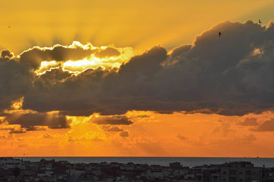 Scenic view of sea against orange sky