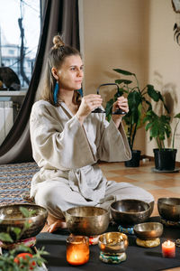 Portrait of young woman sitting at home