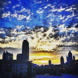 Buildings in city at sunset