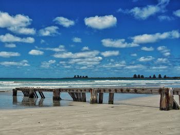 Scenic view of beach against blue sky