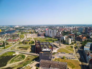 High angle view of city buildings against clear sky