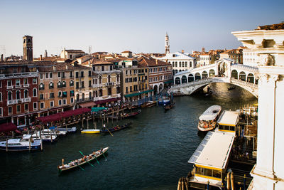 Boats in river with buildings in background