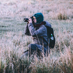 Woman photographing on a field