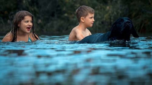 Close-up of children swimming