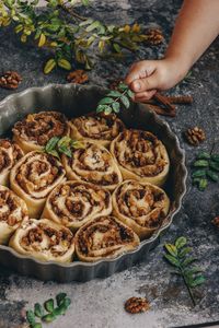 High angle view of hand holding leaves over food