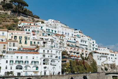 Buildings in town against clear sky