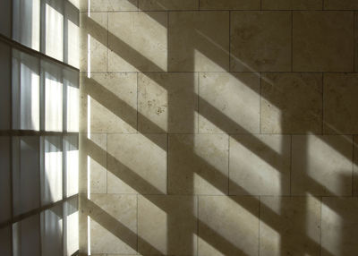 Sunlight falling through windows on wall