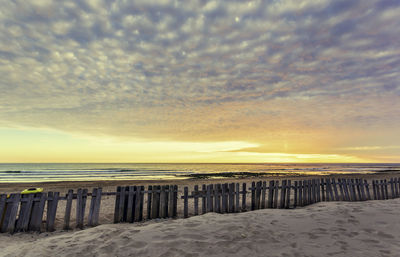 Scenic view of beach against sky during sunset