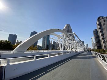 Bridge in city against clear sky