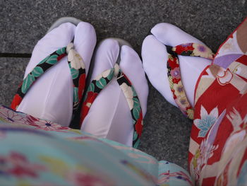 Low section of women wearing tabi and zori on footpath