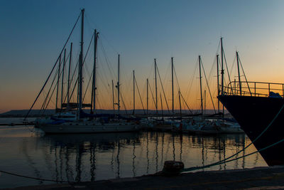 Sailboats in marina at sunset