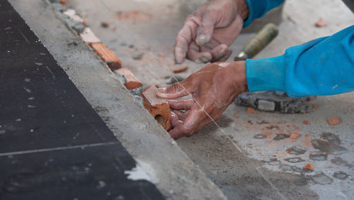 Cropped hands of man working outdoors