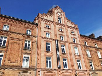 Low angle view of building against blue sky