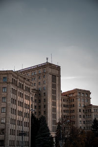 Buildings in city against clear sky