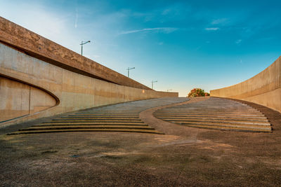 View of empty bridge against blue sky