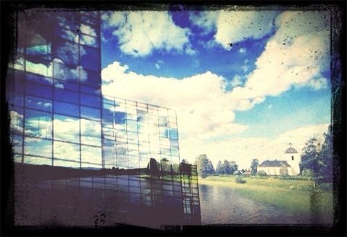 building exterior, architecture, built structure, sky, transfer print, cloud - sky, auto post production filter, city, glass - material, cloud, window, cloudy, building, blue, day, no people, outdoors, residential building, residential structure, house