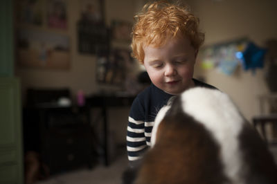 Little boy goes in for a kiss from saint bernard dog