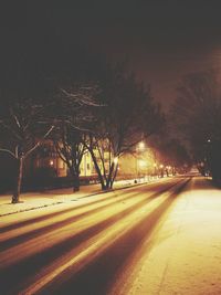 Illuminated road in winter at night