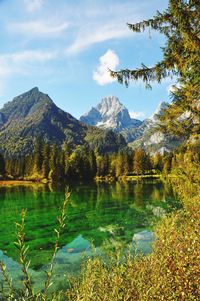 Scenic view of lake and mountains against sky