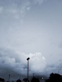 Low angle view of street light against cloudy sky