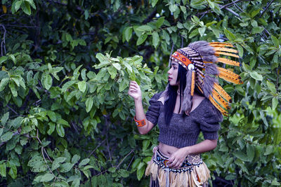 Woman standing by plants