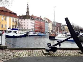 Boats in canal along buildings