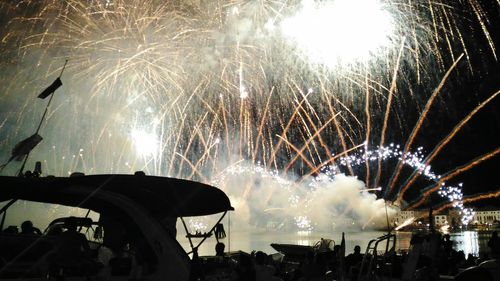 Low angle view of firework display at night