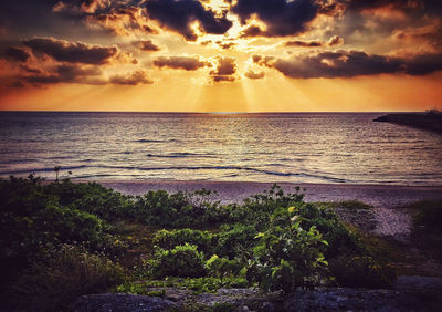 Scenic view of sea against cloudy sky