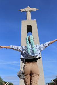 Low angle view of statue against blue sky