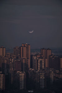 Buildings against sky at night