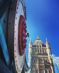 Low angle view of bridge against blue sky