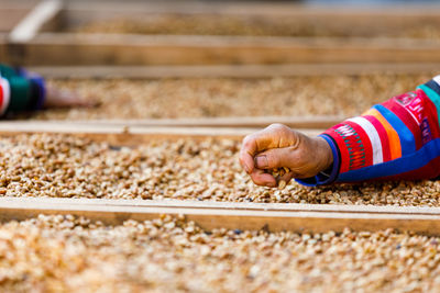 Cropped image of person standing on railroad track