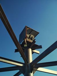 Low angle view of metallic structure against clear blue sky