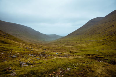 Scenic view of mountains against cloudy sky