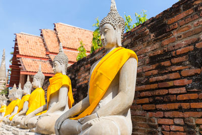 Sculpture of buddha statue outside historic building