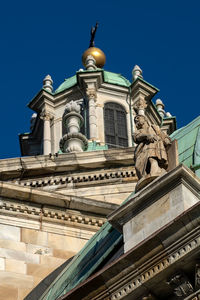 Low angle view of ornate building against clear blue sky