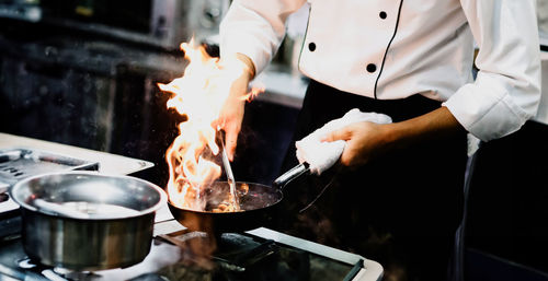 Midsection of man preparing food