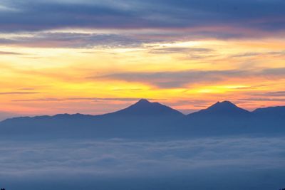 Scenic view of silhouette mountains of sunrire