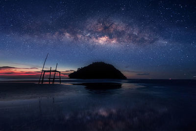 Scenic view of beach against star field