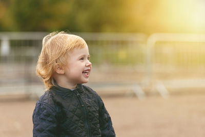 Two years boy is smiling looking to sunlight