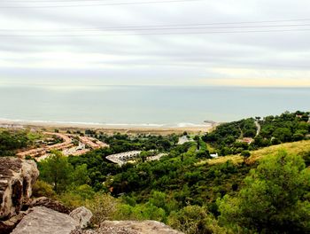 High angle view of trees and sea against sky