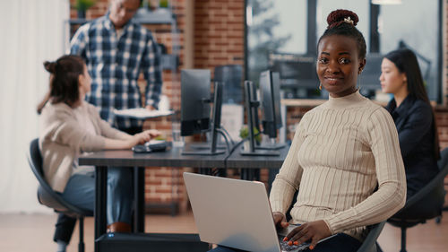 Portrait of smiling businesswoman working at office